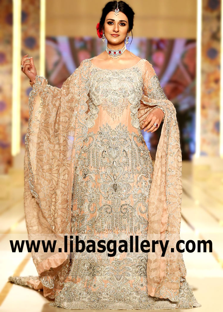 An unforgettable wedding dress for a uniquely beautiful bride Sarah Khan Walima Bridal Lehenga UK USA Canada Madeeha Shoaib Puffy Bridal Dresses for Walima. Edgy and elegant blend together to make an impeccable bridal look. Featuring embellished illusion sleeves, and a striking high end Embroidery with floral motifs, Madeeha Shoaib Bridal Couture Week Puffy Bridal Dress is an ode to the true fashionista.