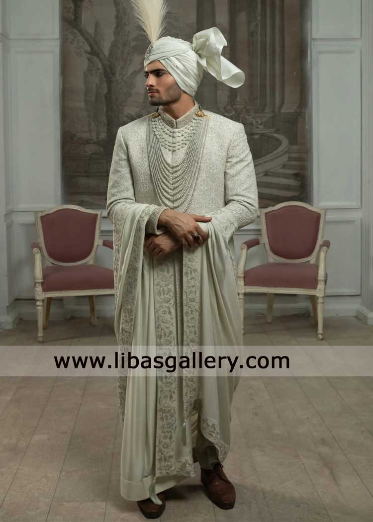 white romantic sherwani with grandeur pearl hand embellishment catches the light paired shawl turban shoes UK USA Canada Dubai Australia white romantic sherwani with grandeur pearl hand embellishment catches the light paired shawl turban shoes UK USA Canada Dubai Australia